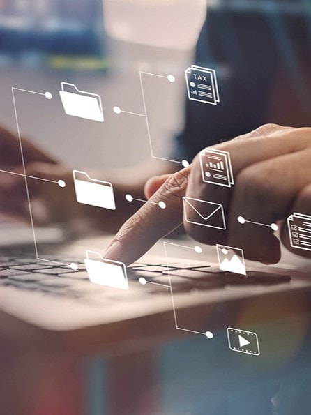 Person sitzt an einem Laptop und tippt in die Tastatur. Es wird eine Datenschutzmanagementsystem gegen Datenpannen angezeigt.