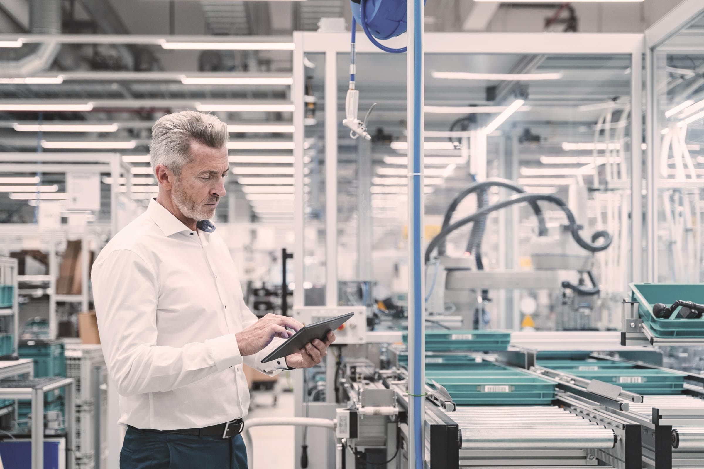 Maschinenbau-Versicherung Hiscox: Mann steht mit Tablet in Produkttionshallepr
